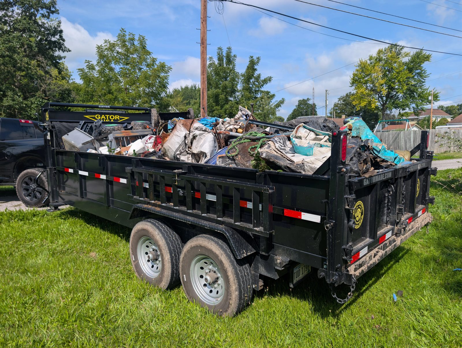 Full 16-foot Findlay Junk Removal trailer loaded to the rails