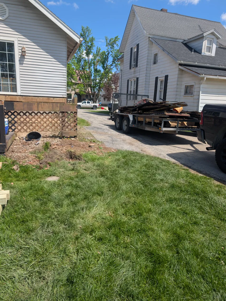 Trailer hauling deck debris from a Findlay home